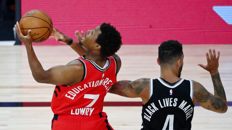 Aug 21, 2020; Lake Buena Vista, Florida, USA; Toronto Raptors guard Kyle Lowry (7) shoots while getting fouled by Brooklyn Nets guard Chris Chiozza (4) during the first half in game three of the first round of the 2020 NBA Playoffs at The Field House. Mandatory Credit: Kim Klement-USA TODAY Sports