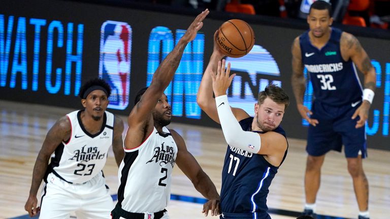 Dallas Mavericks&#39; Luka Doncic looks to pass against the defense of Los Angeles Clippers&#39; Kawhi Leonard