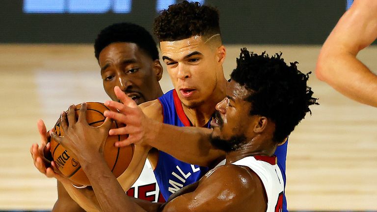 Michael Porter Jr is mobbed by Heat defenders Bam Adebayo and Jimmy Butler