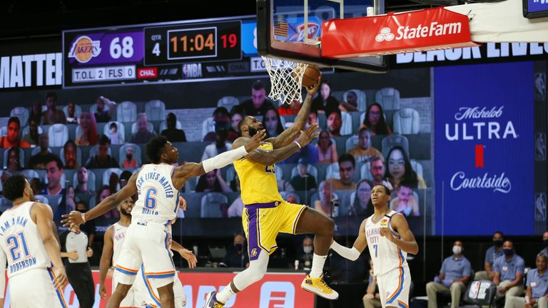 LeBron James went the length of the court as he completes and-one in the fourth quarter of the Lakers NBA encounter with OKC.