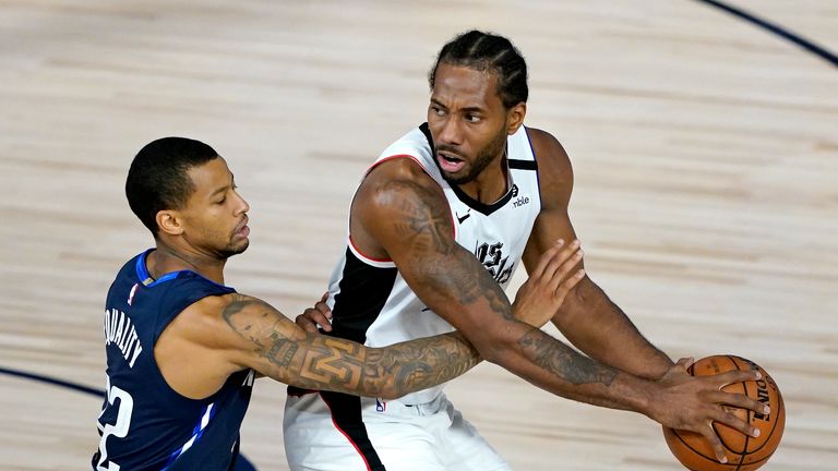 Kawhi Leonard #2 of the Los Angeles Clippers is guarded by Trey Burke #32 of the Dallas Mavericks during the second half of an NBA basketball game at the ESPN Wide World Of Sports Complex on August 6, 2020 in Lake Buena Vista, Florida.