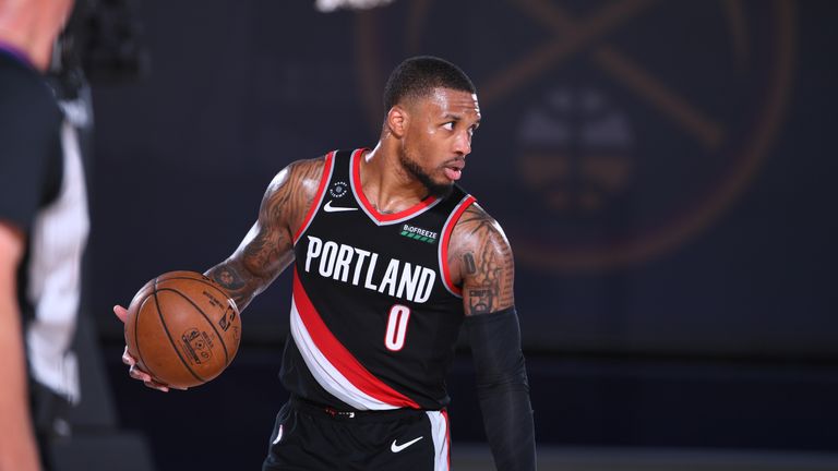  Damian Lillard #0 of the Portland Trail Blazers handles the ball against the Denver Nuggets on August 6, 2020 at Visa Athletic Center at ESPN Wide World of Sports in Orlando, Florida. 
