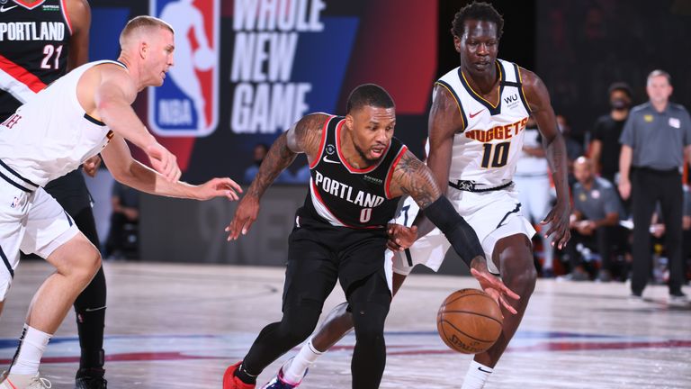 Damian Lillard #0 of the Portland Trail Blazers handles the ball against the Denver Nuggets on August 6, 2020 at Visa Athletic Center at ESPN Wide World of Sports in Orlando, Florida.