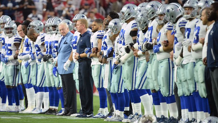 Dallas Cowboys players and owner Jerry Jones locked arms and briefly took a knee on the field before standing on the sideline throughout the playing of the national anthem against Arizona Cardinals in 2017