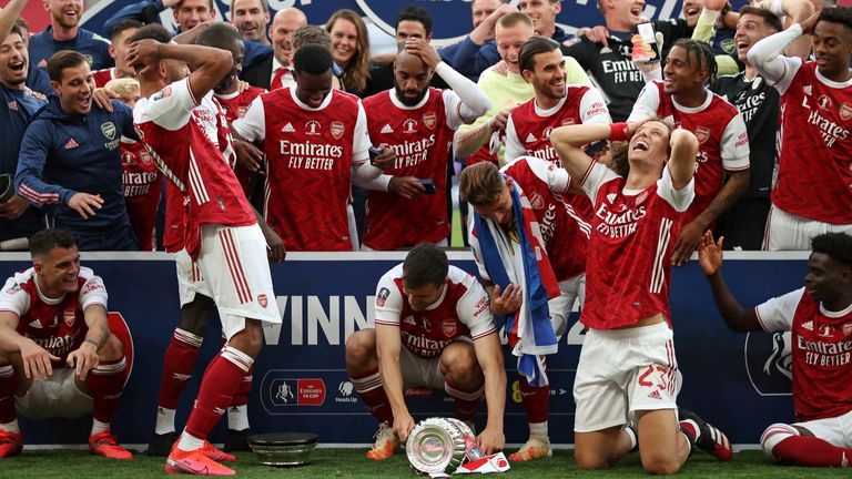 Aubameyang shows his dismay after dropping the FA Cup during the celebrations