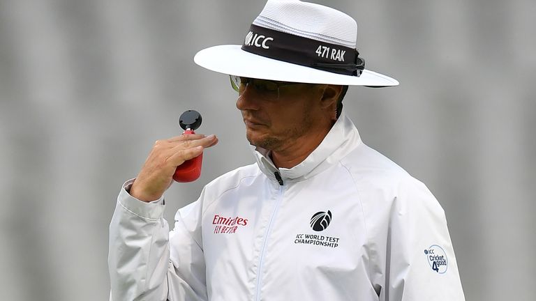 Umpire Richard Kettleborough signals that play is abandoned due to bad light during day one of the 1st Test match between England and Pakistan at Old Trafford