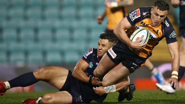 Brumbies full-back Tom Banks is tackled by Matt Toomua of the Rebels in Super Rugby AU