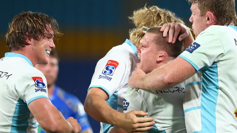 Tom Robertson is congratulated after scoring a try