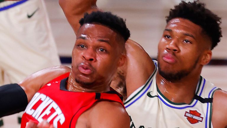 Russell Westbrook throws a pass while being guarded by Giannis Antetokounmpo