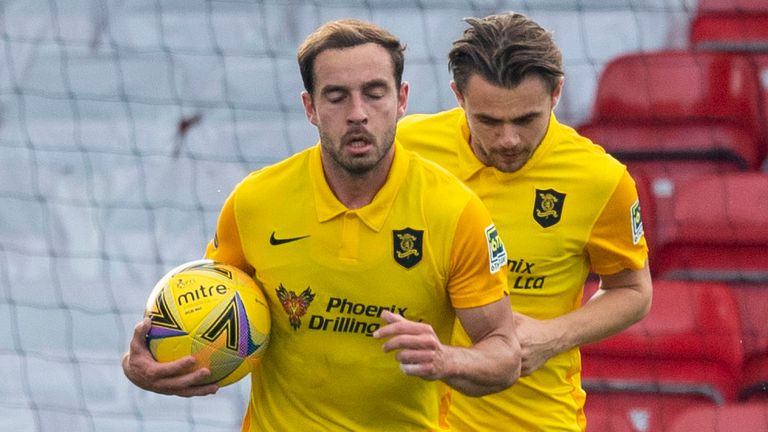 Scott Pittman runs back to the centre circle after pulling a goal back to make it 2-1