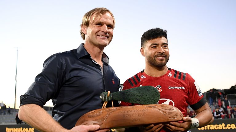 Head coach Scott Robertson (L) and Richie Mo'unga of the Crusaders hold the Super Rugby Aotearoa trophy