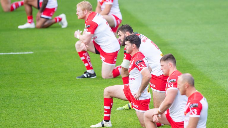 St Helens players take a knee ahead of their game against Catalans