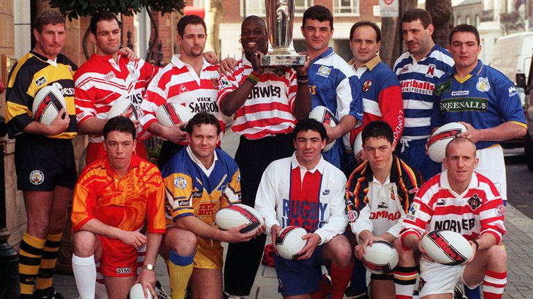 Martin Offiah holds aloft the Sky Sports Stones Super League trophy, at the launch of the league in London. (l/r back) Lee Crooks - Castleford, Dean Busby - St Helens, Paul Topping - Oldham, Martin Offiah - Wigan, Rowland Phillips - Workington, Terry Mattison - London Broncos, Kark Harrison - Halifax and Paul Cullen - Warrington. (l/r front) Mark Aston - Sheffield Eagles, Neil Harmon - Leeds, Patrick Entat - Paris, Robbie Paul - Bradford Bulls and Sean Edwards - Wigan.