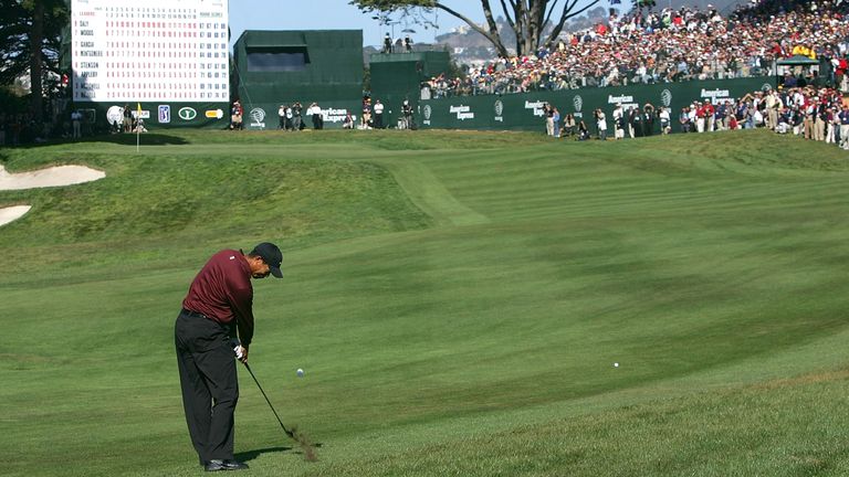 Tiger Woods hits his approach shot on the 18th hole during his sudden death play-off with John Daly in the final round of the WGC American Express Championship on October 9, 2005 at Harding Park Golf Course in San Francisco, California