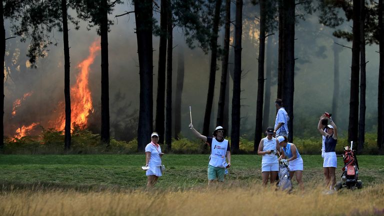 A fire behind the tenth tee stops play on day three of The Rose Ladies Series at Wentworth Golf Club