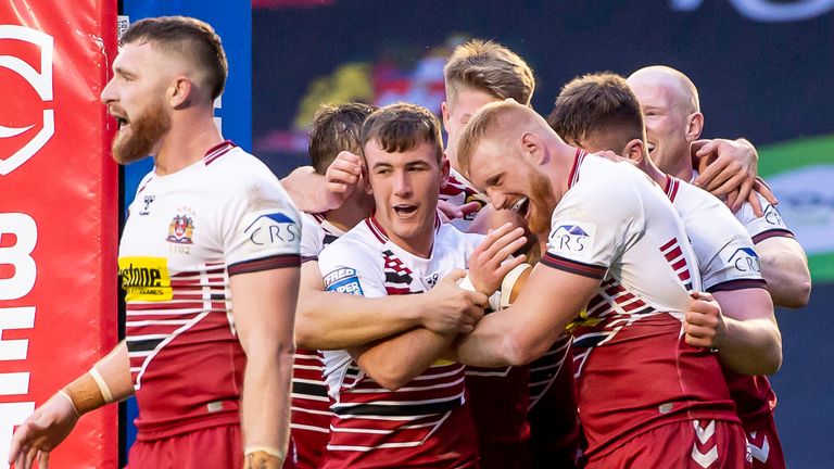 Wigan's Joe Bullock is mobbed by team mates after scoring a try against Castleford.