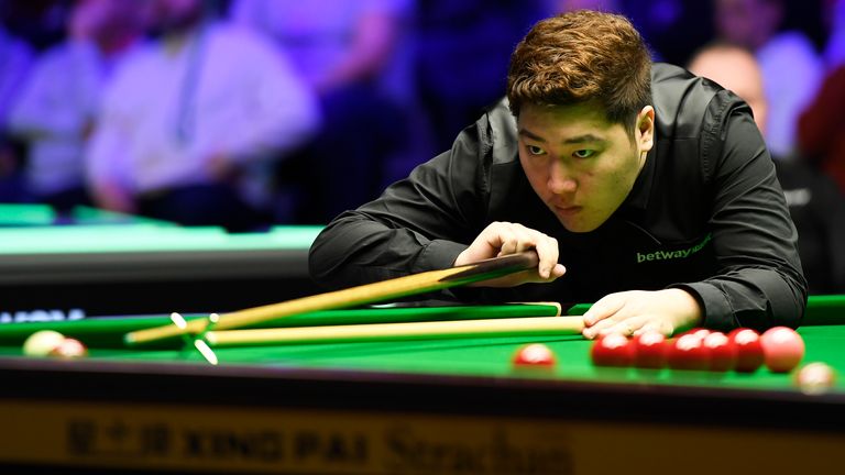 Yan Bingtao plays a shot during his match against John Higgins in the Quater Final of the Betway UK Championship at The Barbican on December 06, 2019 in York, England