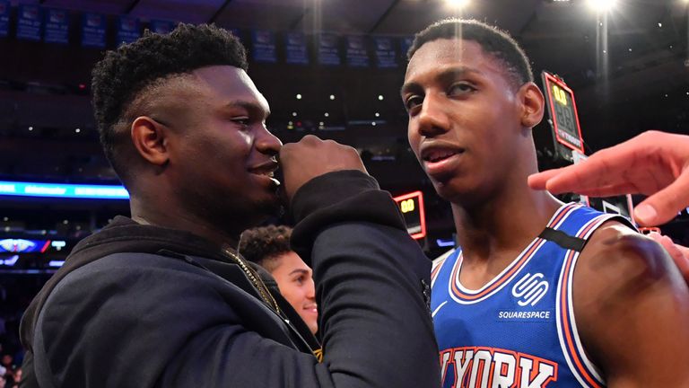 Zion Williamson shares a word with RJ Barrett before a Pelicans-Knicks game