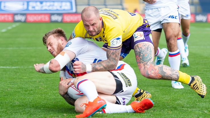 Picture by Allan McKenzie/SWpix.com - 09/08/2020 - Rugby League - Betfred Super League - Wakefield Trinity v Wigan Warriors - Emerald Headingley Stadium, Leeds, England - Wakefield's Tom Johnstone is tackled by Wigan's Zak Hardaker.