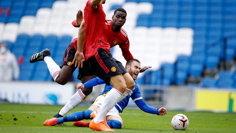 Aaron Connolly goes down inside the penalty area from a challenge by Paul Pogba