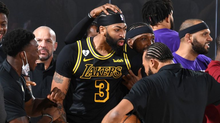 Anthony Davis mobbed by Lakers team-mates and coaches after hitting a game-winning shot in Game 2 of the Western Conference Finals