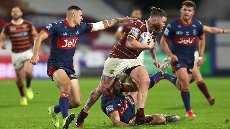 Chris McQueen is tackled by Hull KR's Nick Rawsthorne (left) and Kane Linnett