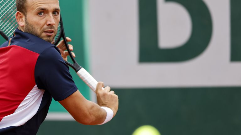 Britain's Dan Evans plays a backhand return to Japan's Kei Nishikori during their men's singles first round tennis match on Day 1 of The Roland Garros 2020 French Open tennis tournament in Paris on September 27, 2020. 