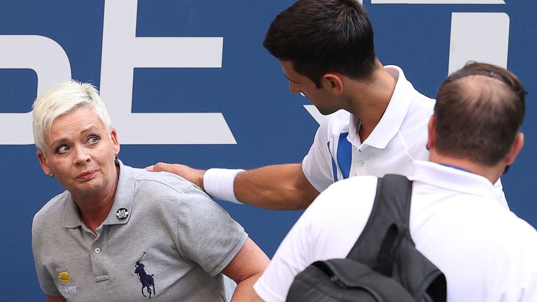 Novak Djokovic consoles the lineswoman after the incident