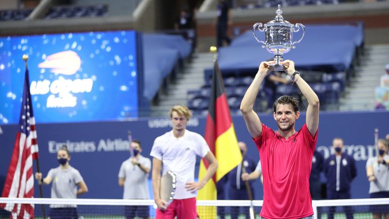 Dominic Thiem (R) of Austria celebrates with championship trophy after winning in a tie-breaker during his Men&#39;s Singles final match against Alexander Zverev (L) of Germany on Day Fourteen of the 2020 US Open at the USTA Billie Jean King National Tennis Center on September 13, 2020 in the Queens borough of New York City.