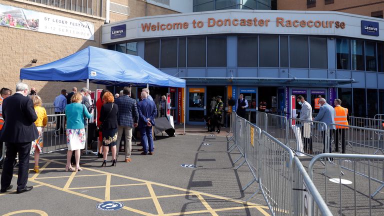 Racegoers make their way into the course as a pilot scheme for the return of crowds to sporting events is expected to bring in 2500 spectators during day one of the William Hill St Leger Festival at Doncaster Racecourse. PA Photo. Picture date: Wednesday September 9, 2020. 