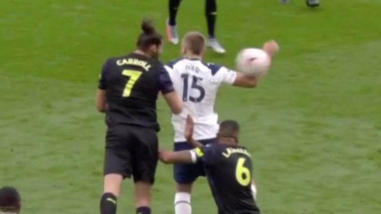 Andy Carroll heads the ball against Eric Dier's arm, as Newcastle are awarded a controversial penalty at Tottenham