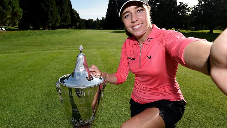 Georgia Hall of England imitates a &#39;selfie&#39; as she poses with the trophy after winning the Cambia Portland Classic at Columbia Edgewater Country Club on September 20, 2020 in Portland, Oregon. 