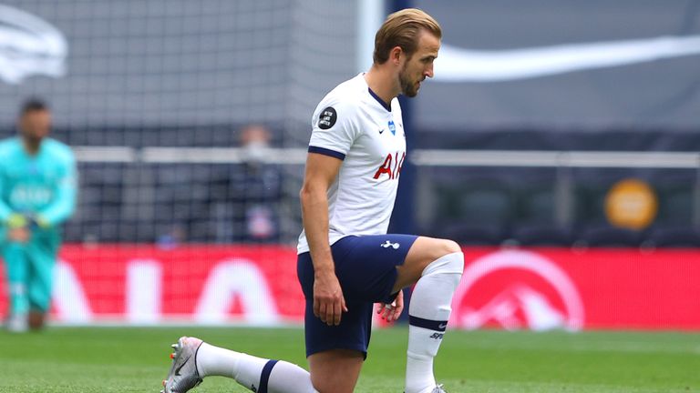  Harry Kane of Tottenham Hotspur takes a knee in support of the Black Lives Matter movement during the Premier League match between Tottenham Hotspur and Leicester City at Tottenham Hotspur Stadium on July 19, 2020 in London, England. Football Stadiums around Europe remain empty due to the Coronavirus Pandemic as Government social distancing laws prohibit fans inside venues resulting in all fixtures being played behind closed doors.