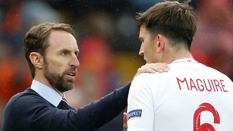 England manager Gareth Southgate speaks to defender Harry Maguire