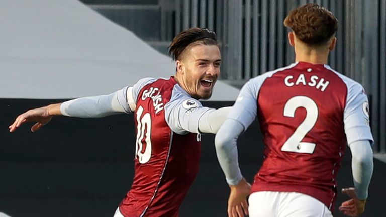 Jack Grealish of Aston Villa celebrates with team-mate Matty Cash after scoring his team's first goal during the Premier League match between Fulham and Aston Villa at Craven Cottage