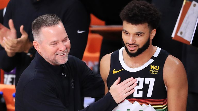 Nuggets coach Mike Malone  congratulates starting guard Jamal Murray