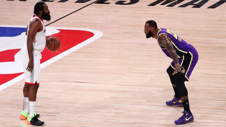 James Harden of the Houston Rockets dribbles the ball against LeBron James of the Los Angeles Lakers during the first quarter in Game One of the Western Conference semi-finals
