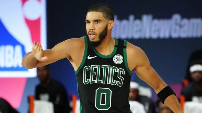 Jayson Tatum high-fives a team-mate after a Boston basket in the team&#39;s Game 2 win over the Raptors