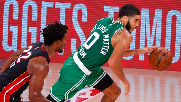 Jayson Tatum of the Boston Celtics drives the ball as Jimmy Butler of the Miami Heat in Game Four of the Eastern Conference Finals