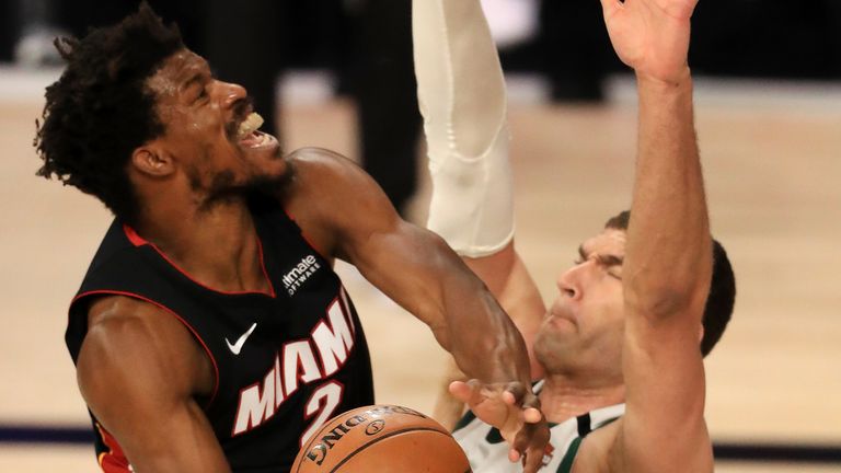 Jimmy Butler attempts to score over Bucks center Brook Lopez