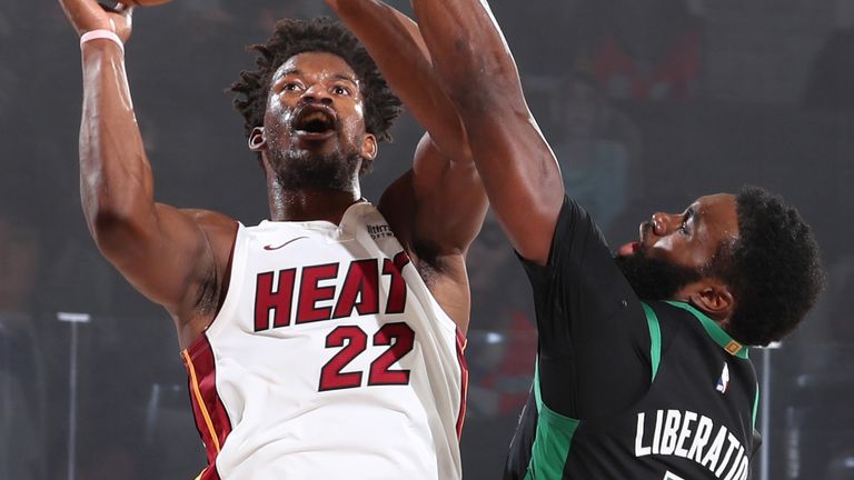 Jimmy Butler attacks the basket despite the attentions of Jaylen Brown in  Game 1 of the Eastern Conference Finals