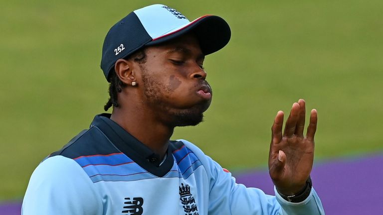 England's Jofra Archer looks at his hand after getting hit by the ball while fielding during the one-day international (ODI) cricket match between England and Australia at Old Trafford in Manchester on September 16, 2020