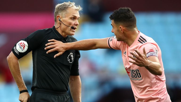 John Egan appeals to match referee Graham Scott before he's shown a red card