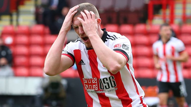 John Lundstram reacts after seeing his shot saved