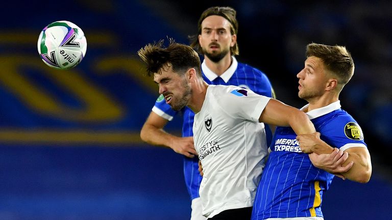 BRIGHTON, ENGLAND - SEPTEMBER 17: John Marquis of Portsmouth battles for possession with Joel Veltman of Brighton and Hove Albion during the Carabao Cup second round match between Brighton And Hove Albion and Portsmouth at Amex Stadium on September 17, 2020 in Brighton, England. (Photo by Glyn Kirk - Pool/Getty Images)