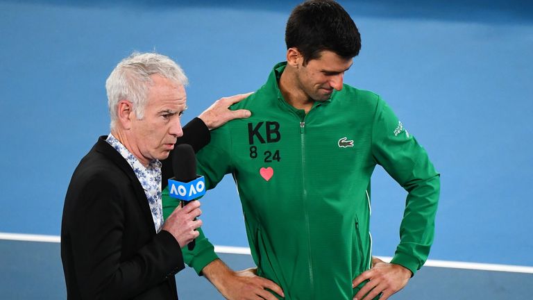 Former US tennis player John McEnroe comforts Serbia's Novak Djokovic as he gets emotional while talking about Kobe Bryant after winning the men's singles quarter-final match against Canada's Milos Raonic on day nine of the Australian Open tennis tournament in Melbourne on January 28, 2020
