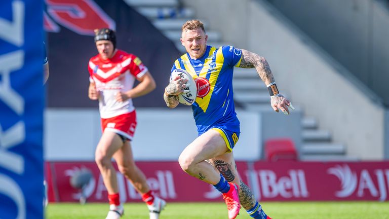 Warrington's Josh Charnley breaks through the St Helens defences to score a try.
