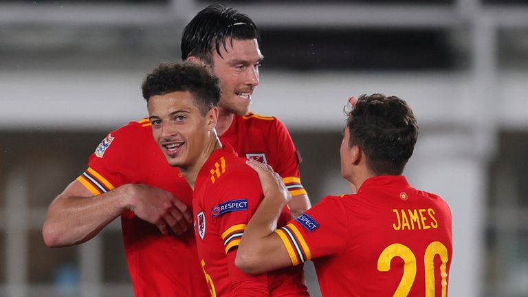 Kieffer Moore of Wales celebrates with team-mates Ethan Ampadu and Daniel James after scoring against Finland