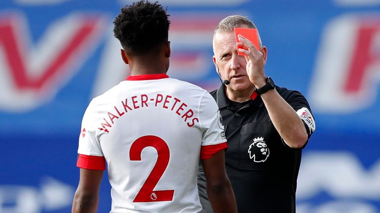 Referee Jonathan Moss shows a red card to Kyle Walker-Peters that is later overturned by VAR