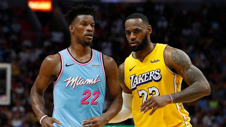 LeBron James #23 of the Los Angeles Lakers guards Jimmy Butler #22 of the Miami Heat during the second half at American Airlines Arena on December 13, 2019 